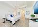 Well-lit main bedroom with a ceiling detail, decorative wall art, and hall access at 15525 Corona Del Mar Dr, Wimauma, FL 33598