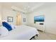 Relaxing bedroom with blue accent pillows, a TV, and a dresser at 15525 Corona Del Mar Dr, Wimauma, FL 33598