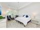 Bedroom with a comfortable bed, chandelier, blue accents, and ample natural light at 15525 Corona Del Mar Dr, Wimauma, FL 33598
