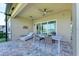 Inviting covered patio with dining area and lounge chair perfect for relaxing and enjoying the water view at 15525 Corona Del Mar Dr, Wimauma, FL 33598