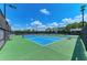 Bright blue and green pickleball courts with black fencing on a clear and sunny day at 15525 Corona Del Mar Dr, Wimauma, FL 33598