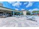 Outdoor dining area with plenty of tables, chairs, umbrellas and a poolside bar at 15525 Corona Del Mar Dr, Wimauma, FL 33598