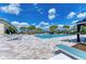 Resort-style swimming pool with sun loungers and shaded cabanas, perfect for relaxation at 15525 Corona Del Mar Dr, Wimauma, FL 33598