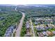 Stunning aerial view showcases a neighborhood surrounded by lush green landscapes and a glimpse of the bay at 1599 Mcauliffe Ln, Palm Harbor, FL 34683