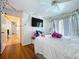 Bedroom view featuring wood floors, a ceiling fan, and door to the outside patio at 1599 Mcauliffe Ln, Palm Harbor, FL 34683