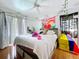 Bedroom featuring a ceiling fan, wood floors and bright natural light at 1599 Mcauliffe Ln, Palm Harbor, FL 34683