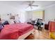 Bright bedroom featuring hardwood floors, ceiling fan and built in shelves at 1599 Mcauliffe Ln, Palm Harbor, FL 34683