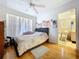 Bedroom featuring wood floors, ceiling fan, bright natural light and ensuite bathroom at 1599 Mcauliffe Ln, Palm Harbor, FL 34683