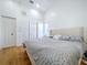 Spacious bedroom with hardwood floors and a comfortable bed, naturally lit at 1599 Mcauliffe Ln, Palm Harbor, FL 34683