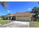 Charming one-story home with attached two car garage and a well-manicured lawn at 1599 Mcauliffe Ln, Palm Harbor, FL 34683