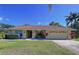 Inviting single-story home with a well-manicured lawn, and mature landscaping at 1599 Mcauliffe Ln, Palm Harbor, FL 34683