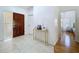 Bright and airy foyer featuring tile flooring and a decorative console table at 1599 Mcauliffe Ln, Palm Harbor, FL 34683
