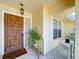 Close-up of a beautiful wooden front door, featuring a classic design and stylish hardware at 1599 Mcauliffe Ln, Palm Harbor, FL 34683
