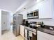 Contemporary kitchen with stainless steel appliances and sleek, clean lines at 1599 Mcauliffe Ln, Palm Harbor, FL 34683