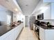Modern kitchen featuring white cabinets, granite countertops, and stainless steel appliances at 1599 Mcauliffe Ln, Palm Harbor, FL 34683