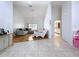 Open-concept living room with tile flooring connects to the kitchen and features a sliding glass door at 1599 Mcauliffe Ln, Palm Harbor, FL 34683