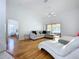 Bright living room featuring wood flooring and access to bedroom and screened patio at 1599 Mcauliffe Ln, Palm Harbor, FL 34683