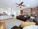 Inviting living room featuring a brick fireplace, built-in shelves, and comfortable seating at 1599 Mcauliffe Ln, Palm Harbor, FL 34683