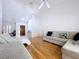 Light-filled living room featuring wood floors, vaulted ceiling, and comfortable seating at 1599 Mcauliffe Ln, Palm Harbor, FL 34683