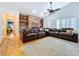 Inviting living room features a brick fireplace with built-in shelving and a large leather sectional at 1599 Mcauliffe Ln, Palm Harbor, FL 34683
