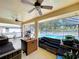 View of screened-in patio with ceiling fans and an outdoor kitchen at 1599 Mcauliffe Ln, Palm Harbor, FL 34683