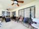 Covered patio with ceiling fans, tile floor, and outdoor seating area at 1599 Mcauliffe Ln, Palm Harbor, FL 34683