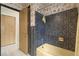 Full bathroom with blue and black mosaic tile at 1675 Robin Hood Ln, Clearwater, FL 33764