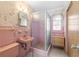 Vintage pink bathroom showcasing butterfly wallpaper and a stand-up shower at 1675 Robin Hood Ln, Clearwater, FL 33764