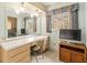 Bedroom vanity with large mirror and television at 1675 Robin Hood Ln, Clearwater, FL 33764