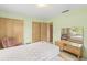 This bedroom features two closets and a mirrored vanity area at 1675 Robin Hood Ln, Clearwater, FL 33764
