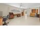 A bonus room featuring ample storage, a ceiling fan, and a window overlooking a patio at 1675 Robin Hood Ln, Clearwater, FL 33764