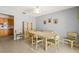 Bright dining room featuring a wooden table with seating for six and retro light fixture at 1675 Robin Hood Ln, Clearwater, FL 33764