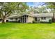 Charming single-story home with stone accents and a well-manicured lawn at 1675 Robin Hood Ln, Clearwater, FL 33764