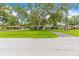 Charming single-story home with mature trees and a well-manicured lawn at 1675 Robin Hood Ln, Clearwater, FL 33764