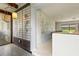 Bright hallway featuring unique wall decor and a view of the pool through the glass at 1675 Robin Hood Ln, Clearwater, FL 33764