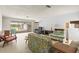 Bright living room featuring a stone fireplace, unique wall decor, and sliding glass doors to the backyard at 1675 Robin Hood Ln, Clearwater, FL 33764