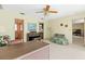 Living room featuring eclectic furniture and decor, patterned wallpaper, and multiple doorways at 1675 Robin Hood Ln, Clearwater, FL 33764