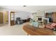Bright living room featuring a stone fireplace, unique wall decor, and terrazzo flooring at 1675 Robin Hood Ln, Clearwater, FL 33764