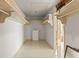 Organized walk-in closet with built-in shelving and a view into the bathroom at 1675 Robin Hood Ln, Clearwater, FL 33764