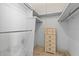 Walk-in closet with a dresser and built-in shelving at 1675 Robin Hood Ln, Clearwater, FL 33764