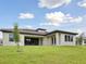 Home exterior with green lawn and off-white paint under partly cloudy skies at 174 Hidden Estates Ct, Brandon, FL 33511