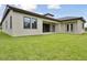 Spacious backyard with green grass, patio, and neutral-colored exterior paint at 174 Hidden Estates Ct, Brandon, FL 33511
