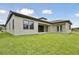 Spacious backyard showcasing the home's facade and ample green space at 174 Hidden Estates Ct, Brandon, FL 33511