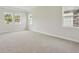 Bright bedroom with large windows and neutral carpeting creates a serene and inviting atmosphere at 174 Hidden Estates Ct, Brandon, FL 33511