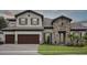 Charming two-story home with stone accents, a three-car garage, and landscaped yard at 174 Hidden Estates Ct, Brandon, FL 33511