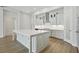 A bright, modern kitchen with a large island, stainless steel appliances, and white cabinets at 174 Hidden Estates Ct, Brandon, FL 33511