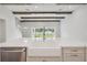 Bright open kitchen boasts large marble island, farmhouse sink, and backyard views at 174 Hidden Estates Ct, Brandon, FL 33511