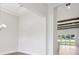 A bright living room area with wooden beams and large glass doors that open to the outside at 174 Hidden Estates Ct, Brandon, FL 33511