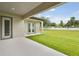 Covered patio with view of spacious yard, seamlessly blending indoor and outdoor living at 174 Hidden Estates Ct, Brandon, FL 33511