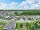 Aerial view featuring a pond, mature trees, and homes in a residential area at 17845 Cortes Creek Blvd, Spring Hill, FL 34610